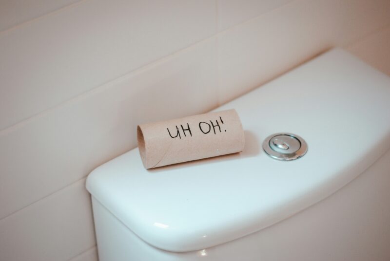 A roll of toilet paper sitting on top of a toilet