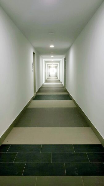 White concrete hallway with white wall