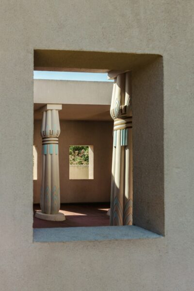White and brown concrete pillar in a courtyard.