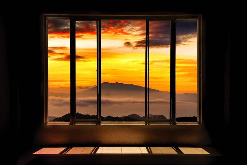Mt. Kanla-on through the window towards the sunset.