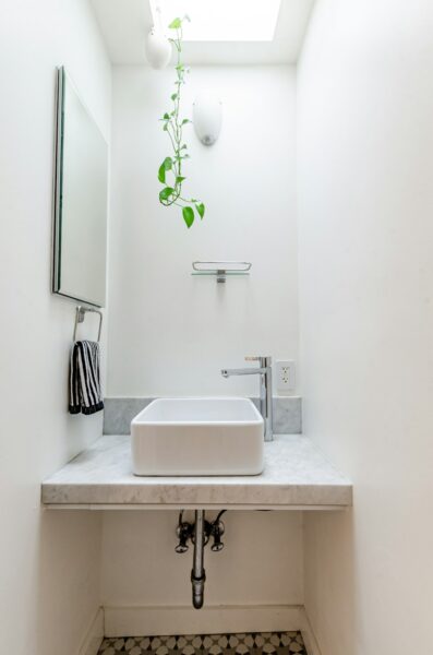 Tiny white bathroom in a Brooklyn NYC apartment.