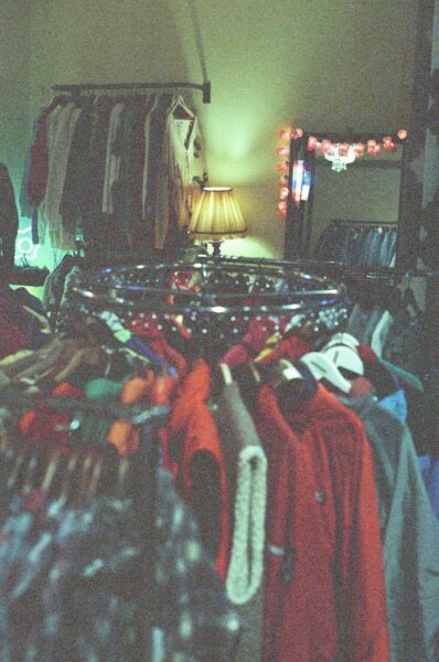 Assorted clothes hanged on rack