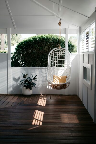 White bird cage on brown wooden floor