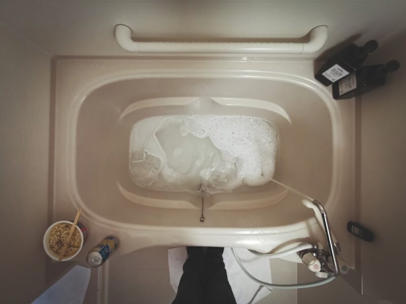 White ceramic bathtub with a plastic bag.