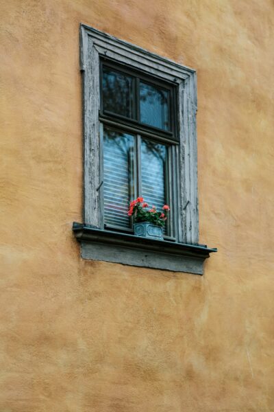Old vintage house front with wooden framed classic window