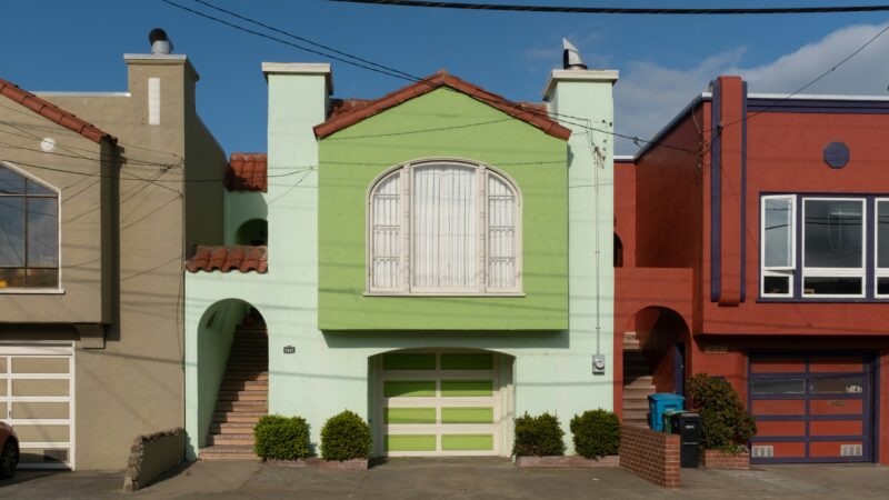 A white and red concrete building in the Outer Sunset neighborhood in San Francisco.