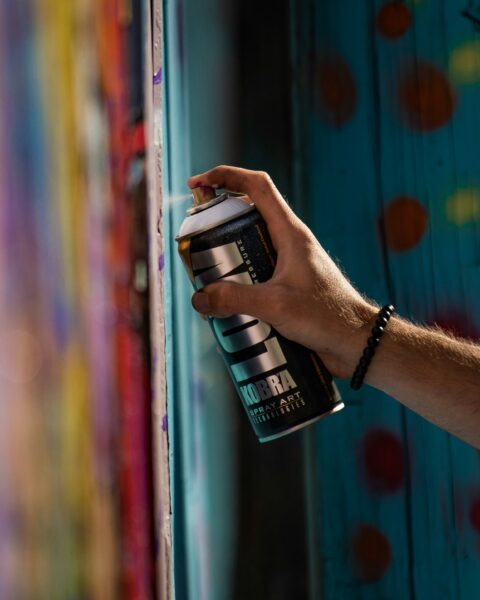 Person holding black and silver can