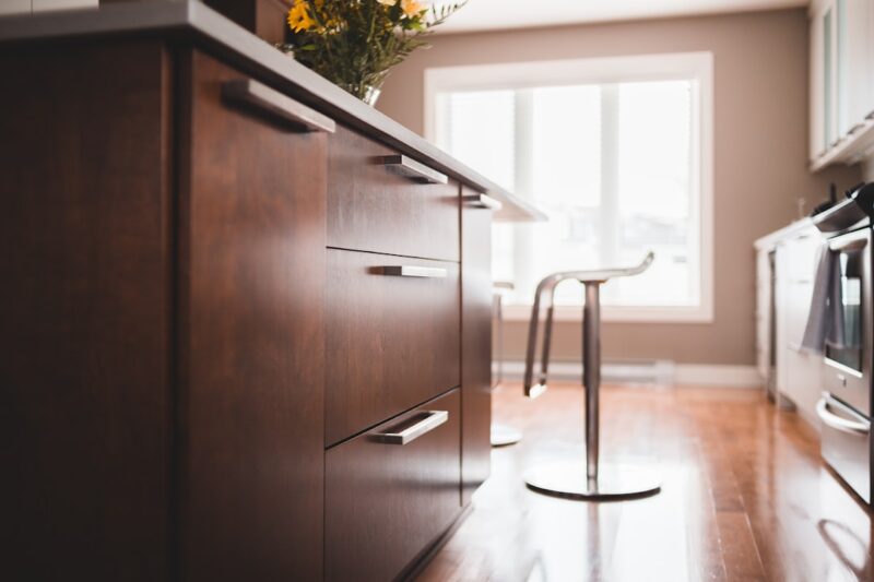 Brown wooden cabinet near brown wooden door