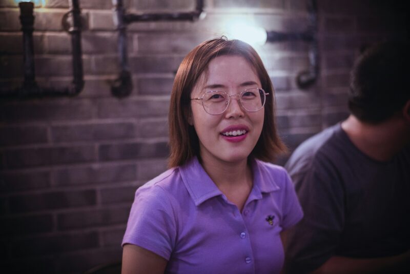 Woman in purple polo shirt smiling