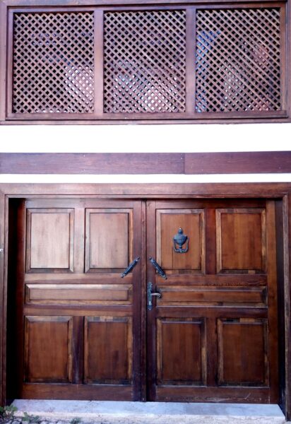 Brown wooden door with silver steel frame
