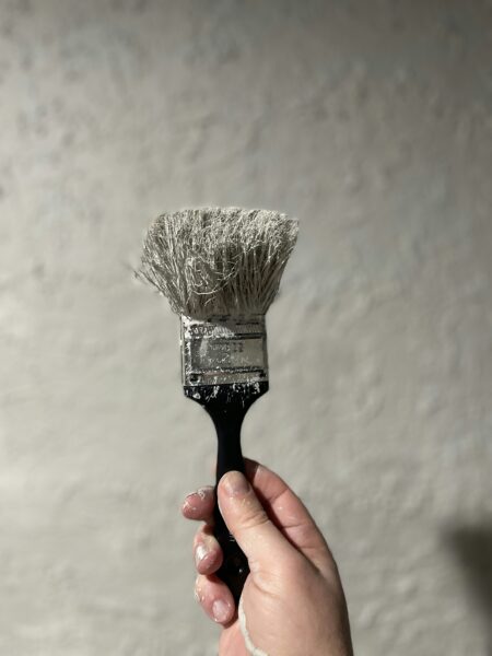 Person holding black and white brush