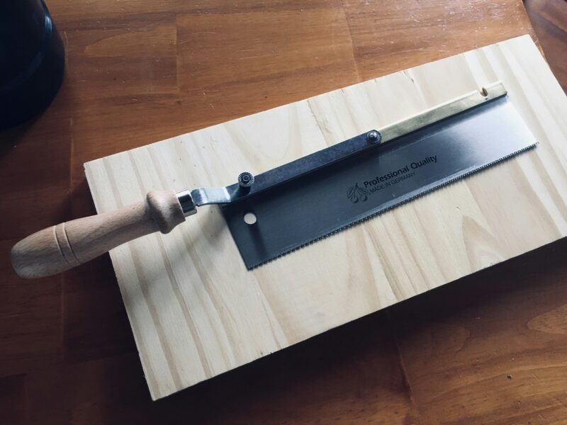 Brown wooden handle on brown wooden table.