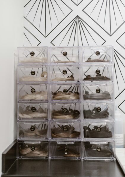 A large clear drawer with many pairs of shoes in it
