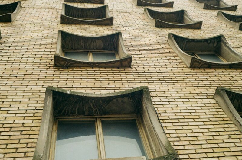 A brick building with a clock on the front of it