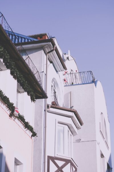 A tall white building with a clock on its side.