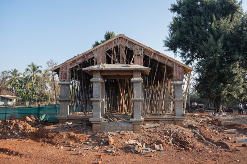 Wooden structure sitting on top of a dirt field.