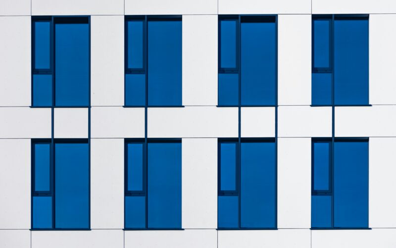 A white and blue building with blue windows