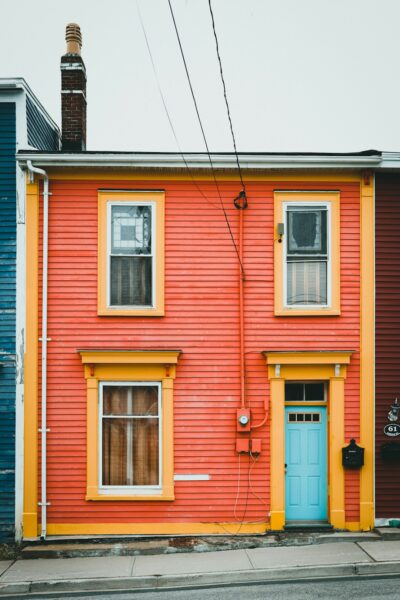 A red building with a blue door and windows