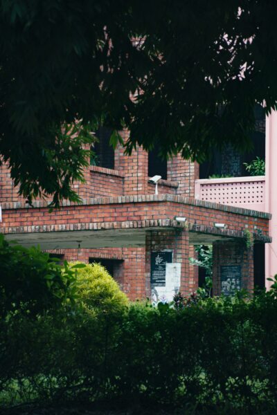 A brick building with a clock on the front of it.
