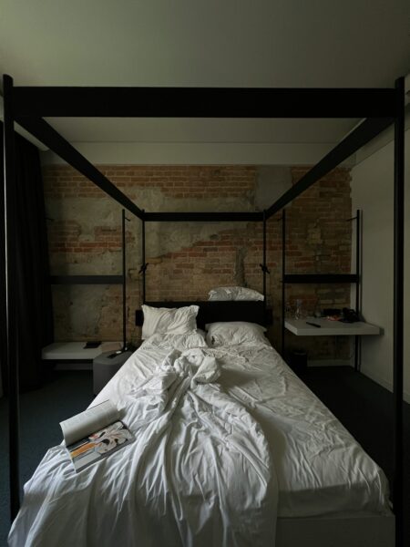 A bed with a white sheet