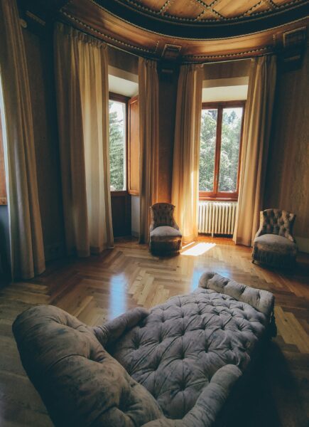 A room with a couch and curtains