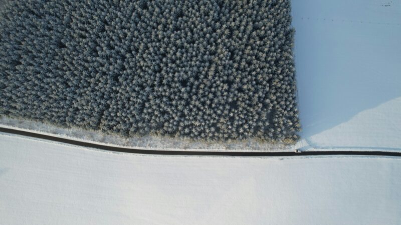 an aerial view of a snow covered field