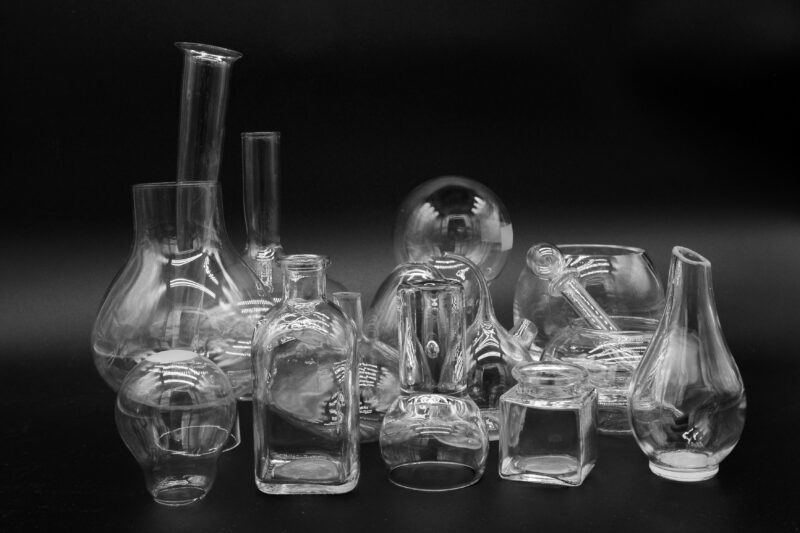 A black and white photo of a group of glass items