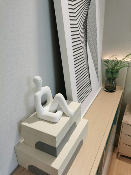 A white sculpture sitting on top of a wooden table.