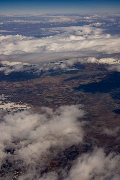 Aerial view of clouds and land from an airplane