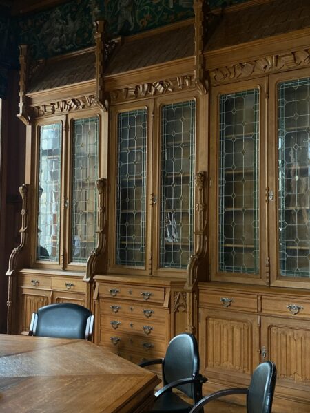 A dining room with a wooden table and chairs