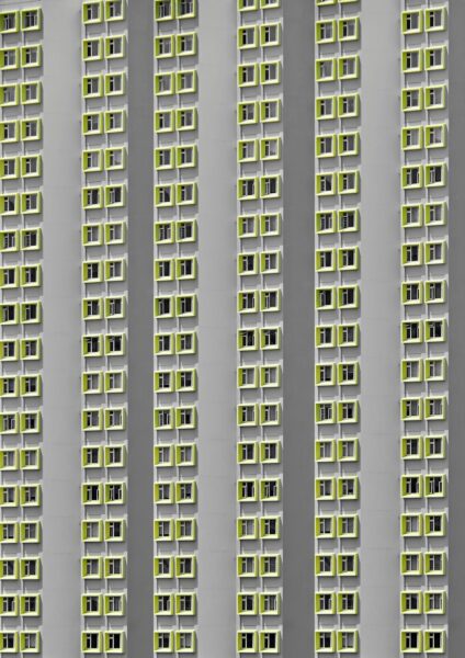 A tall building with lots of windows and green shutters