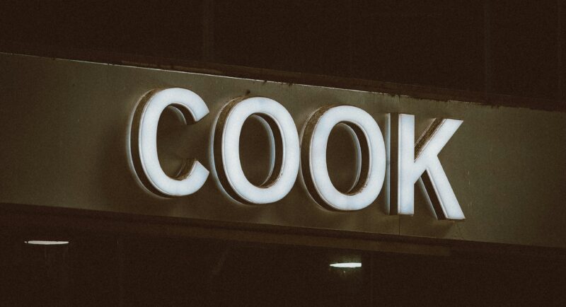 A close up of a sign that reads cook