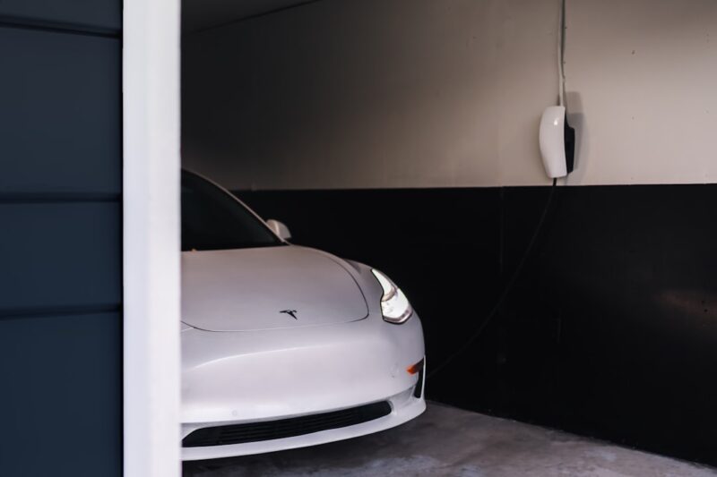A white car parked in a contemporary garage addition.