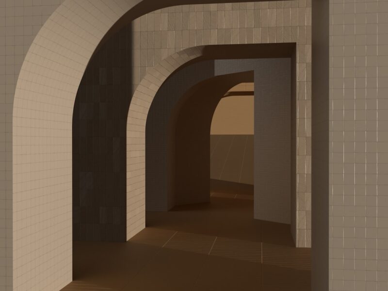 A long hallway with a white brick wall.