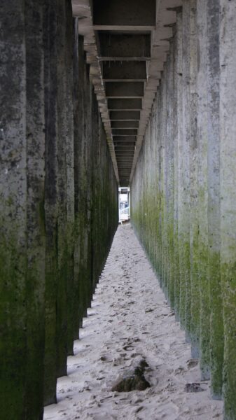 A long walkway with a train going through it