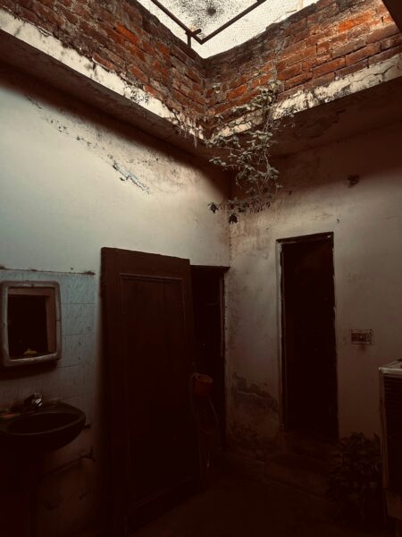 A bathroom with a skylight and a sink.