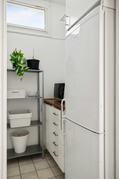 A white refrigerator freezer sitting inside of a kitchen