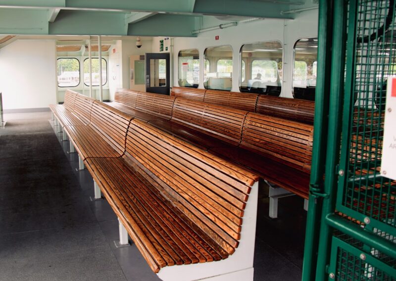 A long wooden bench sitting inside of a building