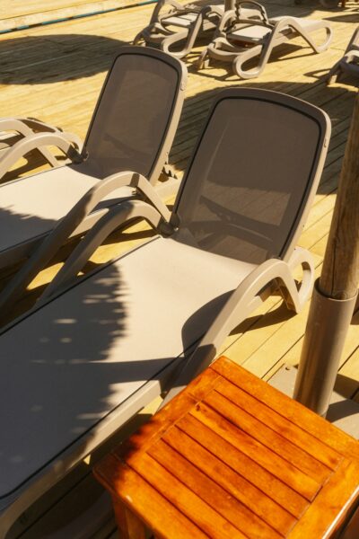 A row of chairs sitting on top of a wooden deck