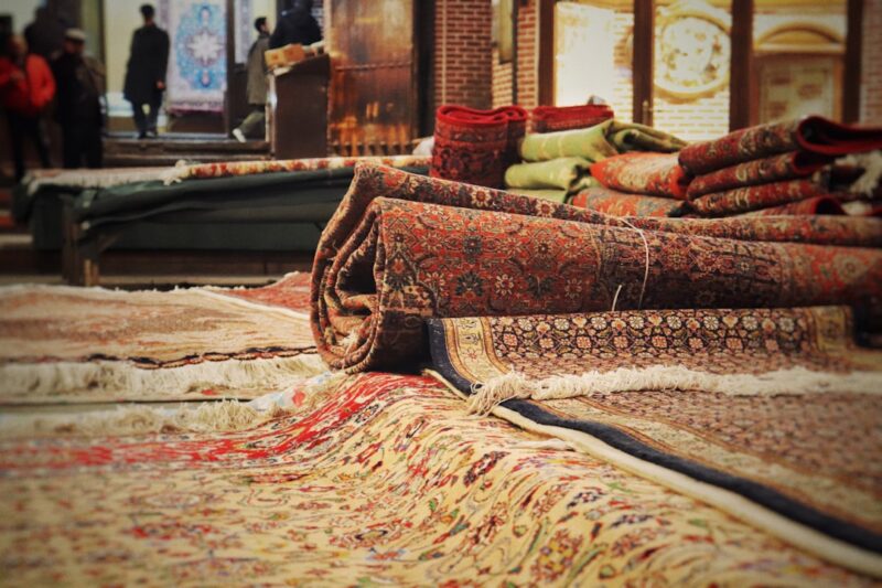 A pile of rugs sitting on top of a floor.