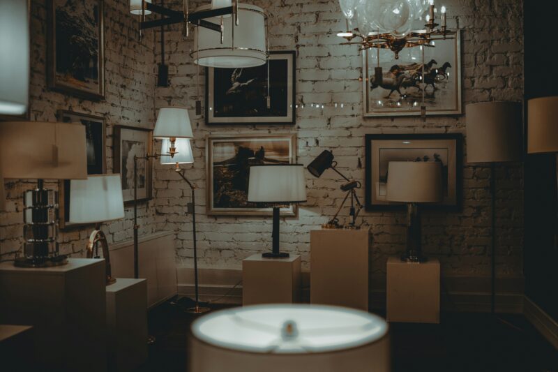 Lamps and artwork decorate a dimly lit room.