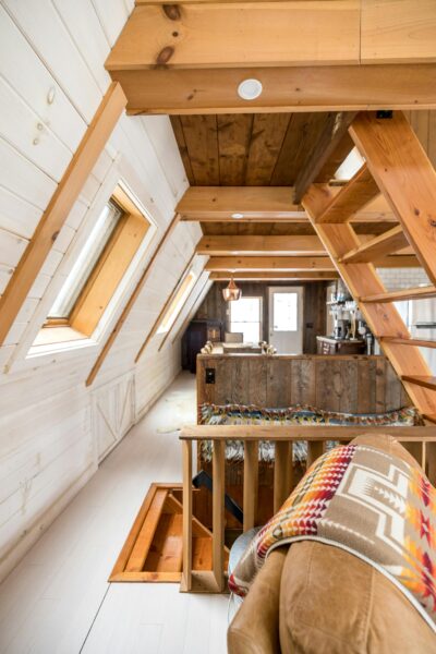 Warm, inviting rustic-style attic room with wooden paneling and cozy design elements.