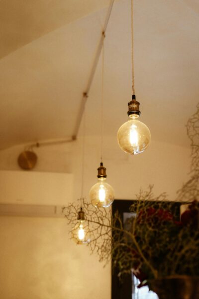 Warm vintage light bulbs hanging in a cozy indoor setting with a soft glow.