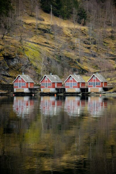 Red houses reflect perfectly on the water.