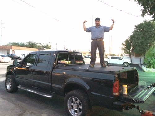 Pest Control Specialist Posing on Heavy-Duty Truck Bed Cover