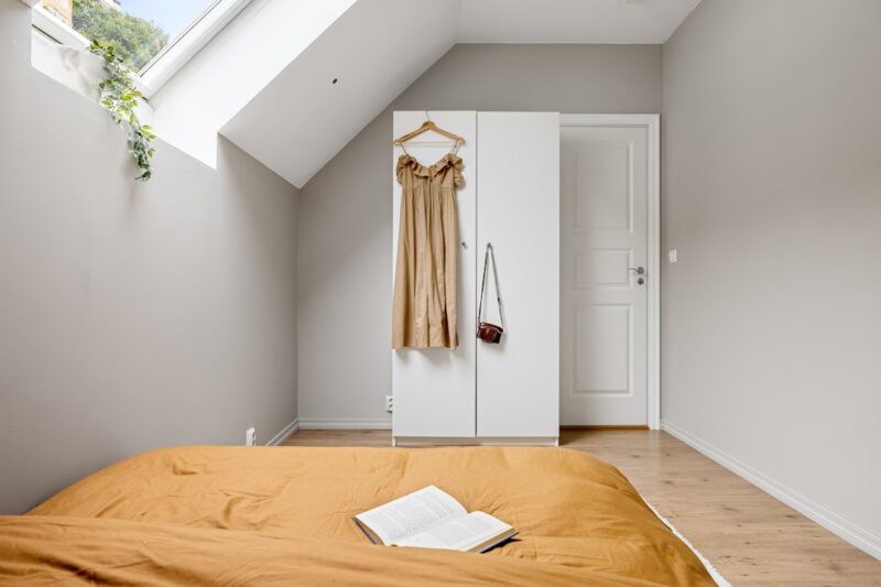 A bedroom with a bed and a skylight