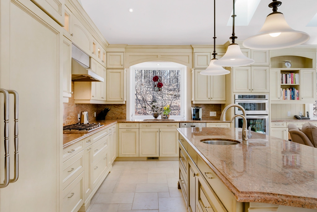 High-gloss ceramic tile backsplash reflecting light in a minimal small kitchen.
