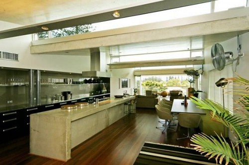 Modern interior design of small open plan kitchen featuring bold geometric backsplash patterns.