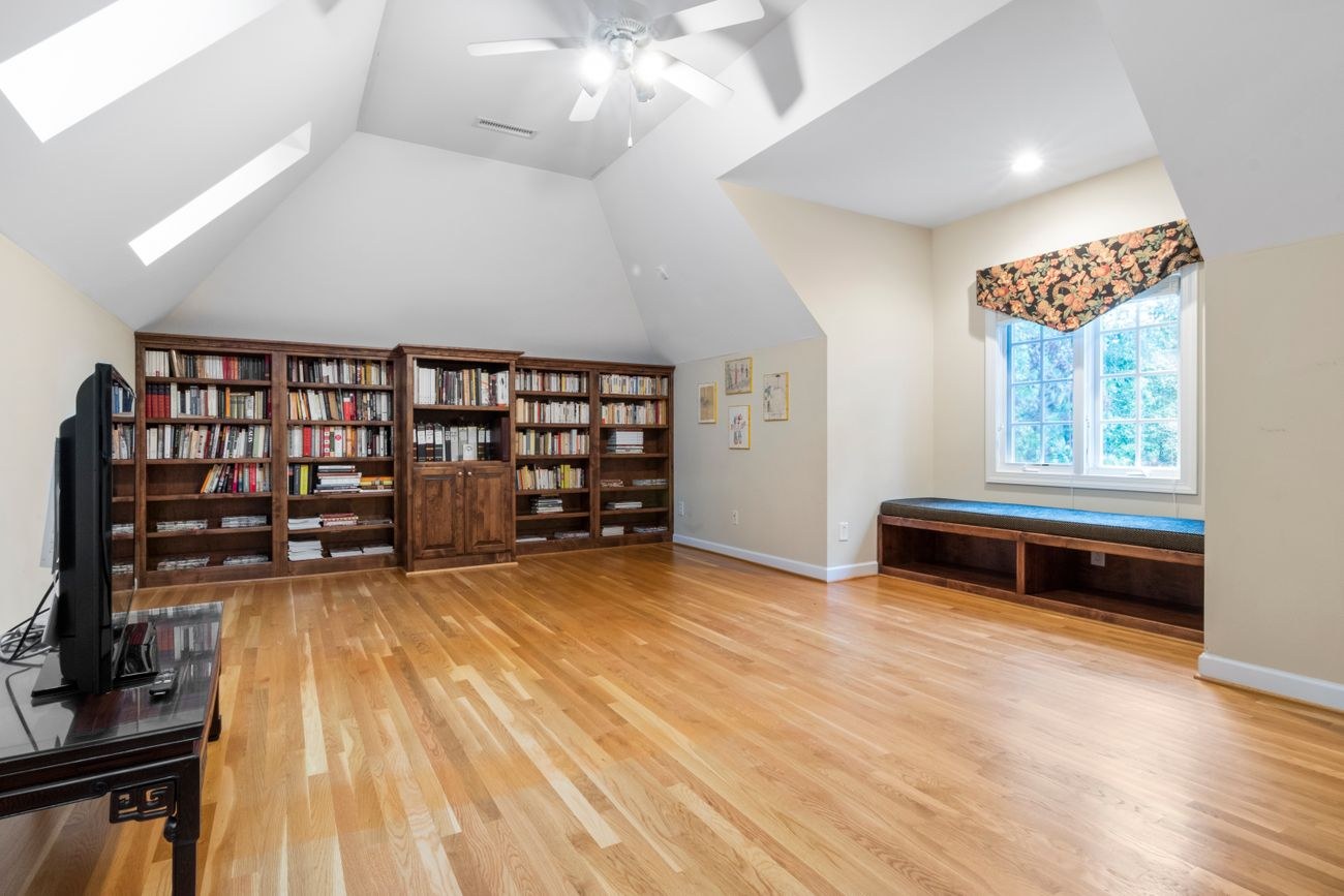 Attic room with a large bookcase and natural light