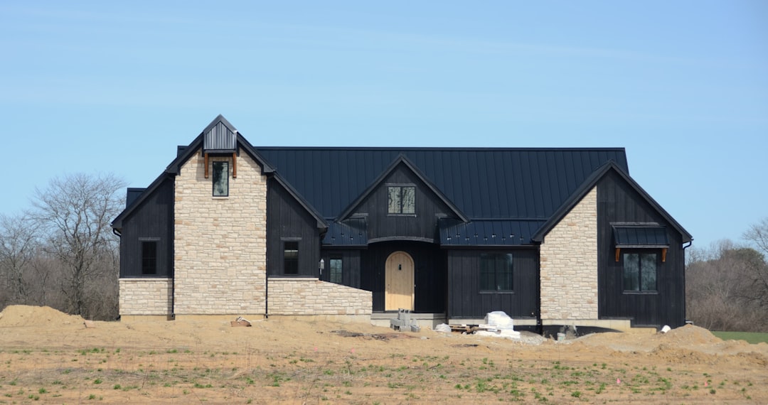 Modern black and stone house under construction